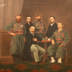 Schilderij van Zouaaf Weerts en gezelschap.
V.l.n.r. Henricus Weerts met kepie, naast hem Edouard, zoon van (zittend met baard), Graaf Villers de Masbourg. Zouaaf midden met armen over elkaar en zouaaf zittend aan tafel, volgens opgave A.J. Heinen, en H. Broeren.
Het schilderij bevindt zich in de Kluis.